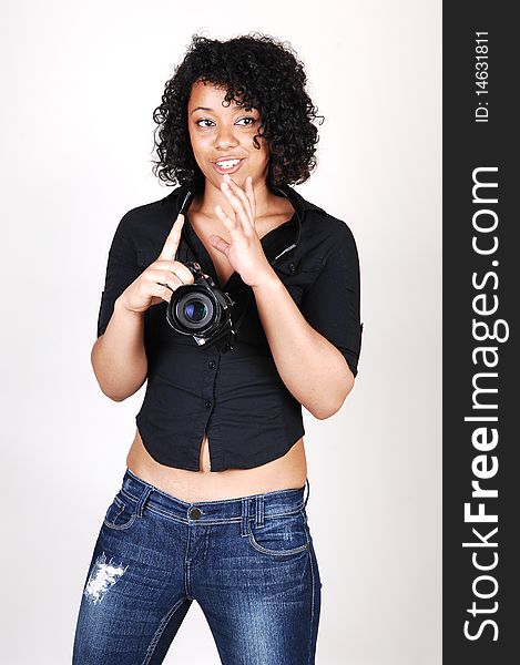 A pretty Hispanic woman looking at her new camera to find the right
setting for the next picture, in a black blouse and jeans, over light gray. A pretty Hispanic woman looking at her new camera to find the right
setting for the next picture, in a black blouse and jeans, over light gray.