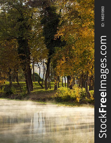 Fog rising over the river in the autumn evening.