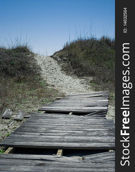 Old broken up boardwalk leading to the beach. Old broken up boardwalk leading to the beach.