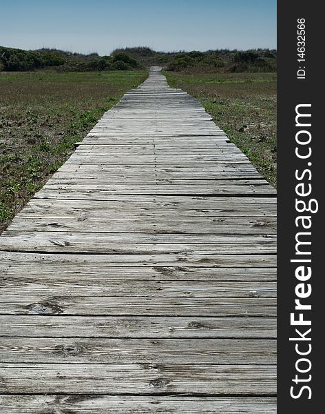 Old broken up boardwalk leading to the beach. Old broken up boardwalk leading to the beach.