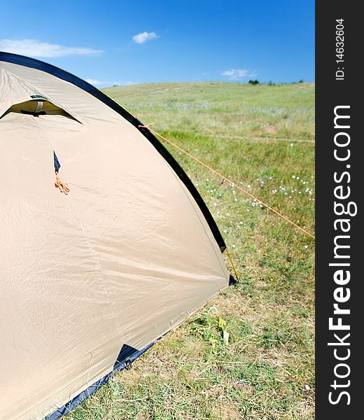 Tent and camping equipment on the green grass. Tent and camping equipment on the green grass