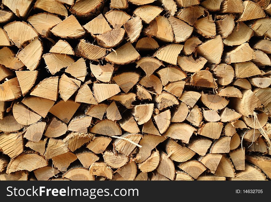 A close up view of a pile of stacked firewood. A close up view of a pile of stacked firewood