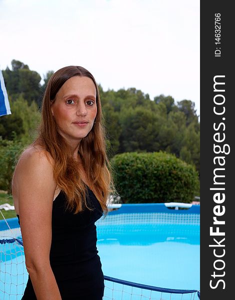 Blond woman standing near the pool. Blond woman standing near the pool