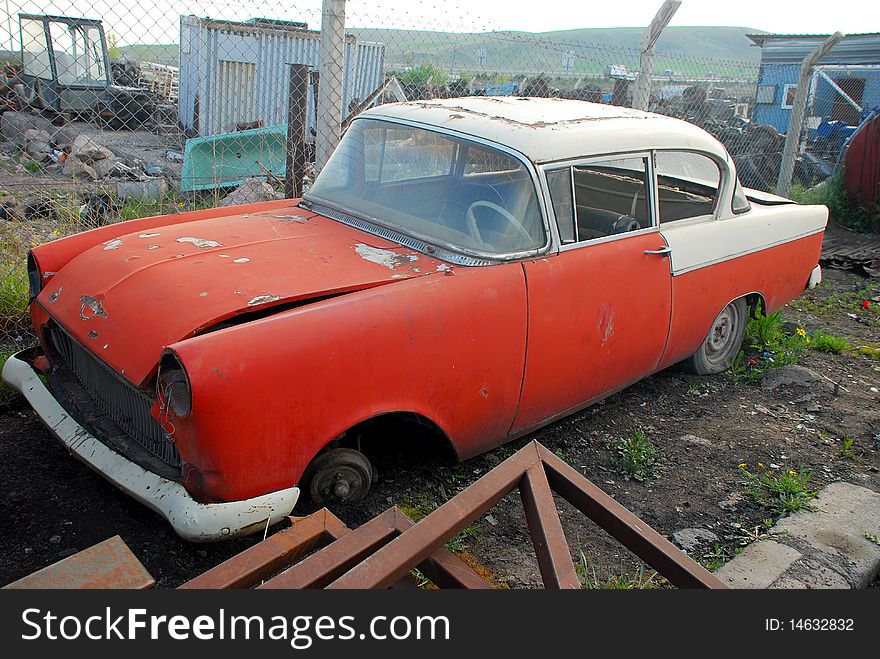 Old rusted American car and junked car. Old rusted American car and junked car