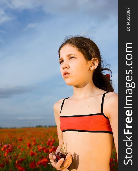 Portrait teen girl with cherry on nature