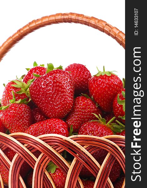 Ripe strawberry in wicker basketbasket isolated on a white background