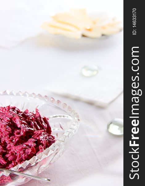 Salad from red beet on glass plate