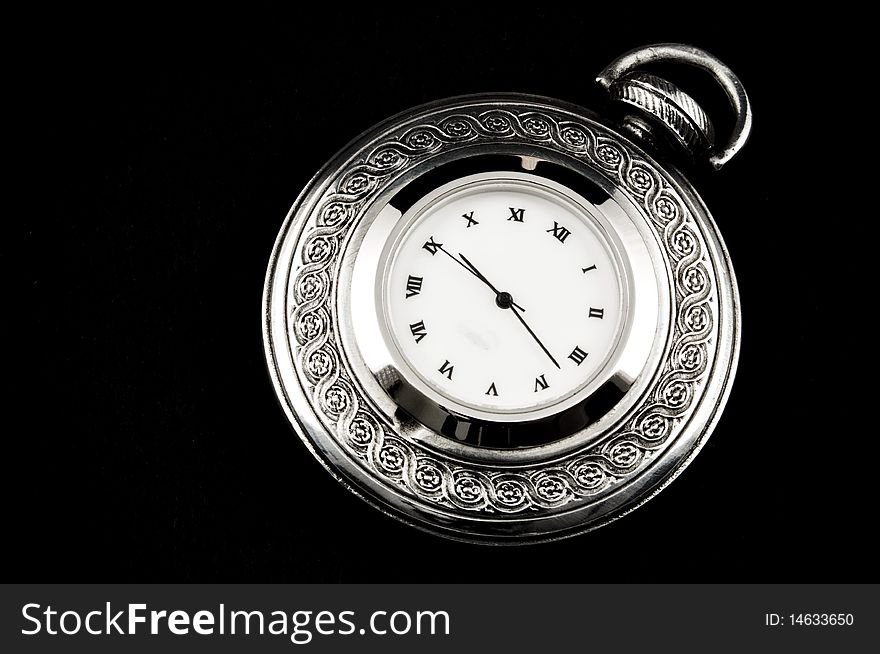 Elegant carved steel pocket watch, isolated on black. Elegant carved steel pocket watch, isolated on black