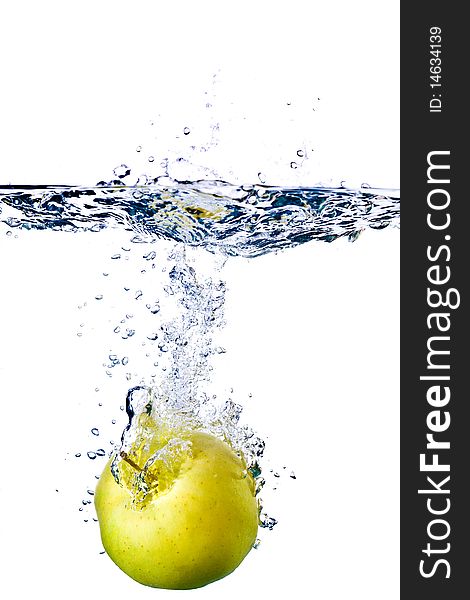 Green apple splashing into water isolated on white background. Green apple splashing into water isolated on white background