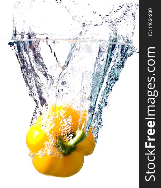 Water splash on yellow pepper isolated on white. Water splash on yellow pepper isolated on white