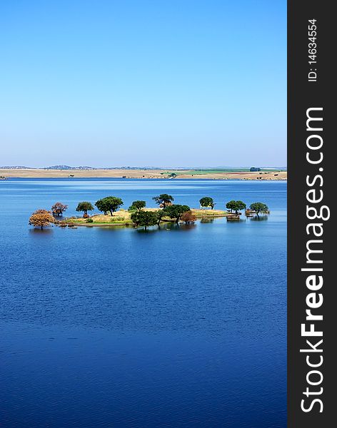 Island in blue Lake, Alentejo, Portugal. Island in blue Lake, Alentejo, Portugal.