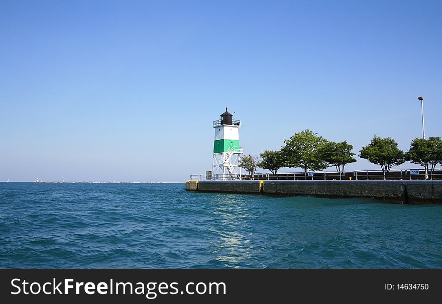 Green lighthouse on a lake