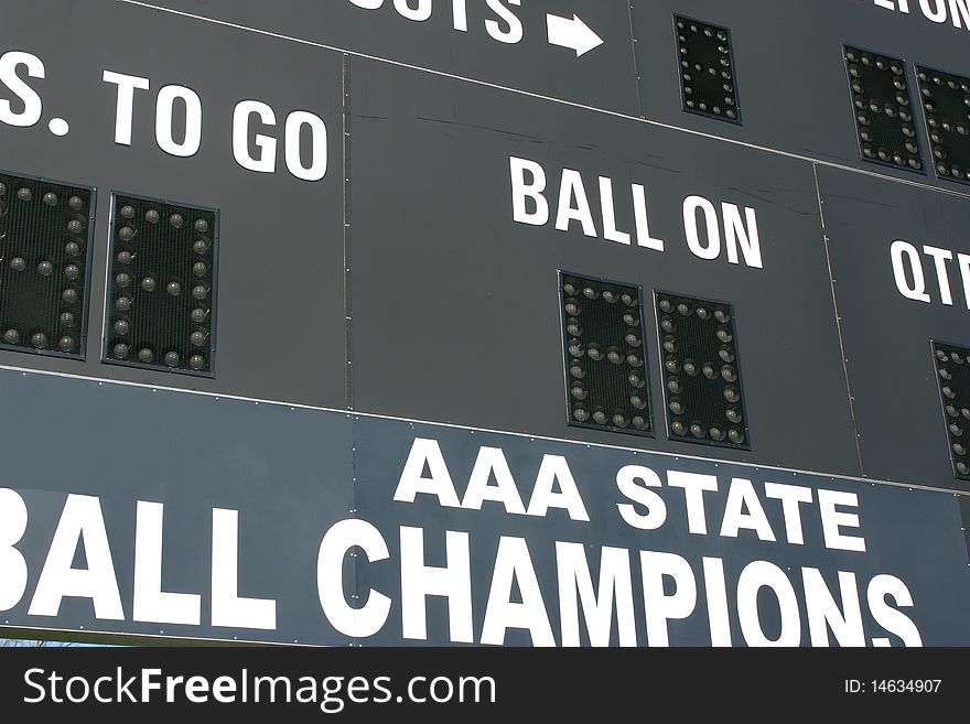 An American football scoreboard with State Champions logo. An American football scoreboard with State Champions logo.