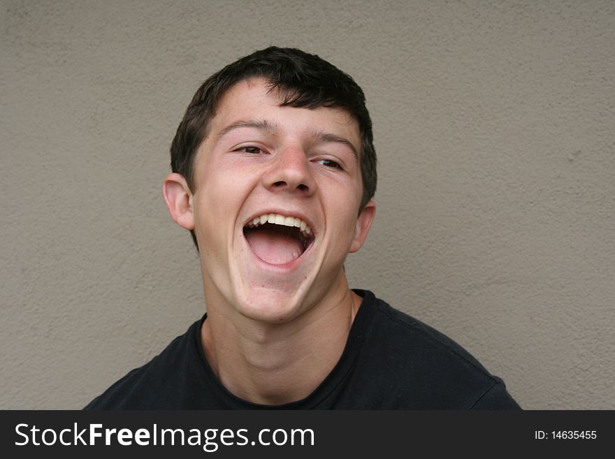 Head shot of a young man laughing. Head shot of a young man laughing.