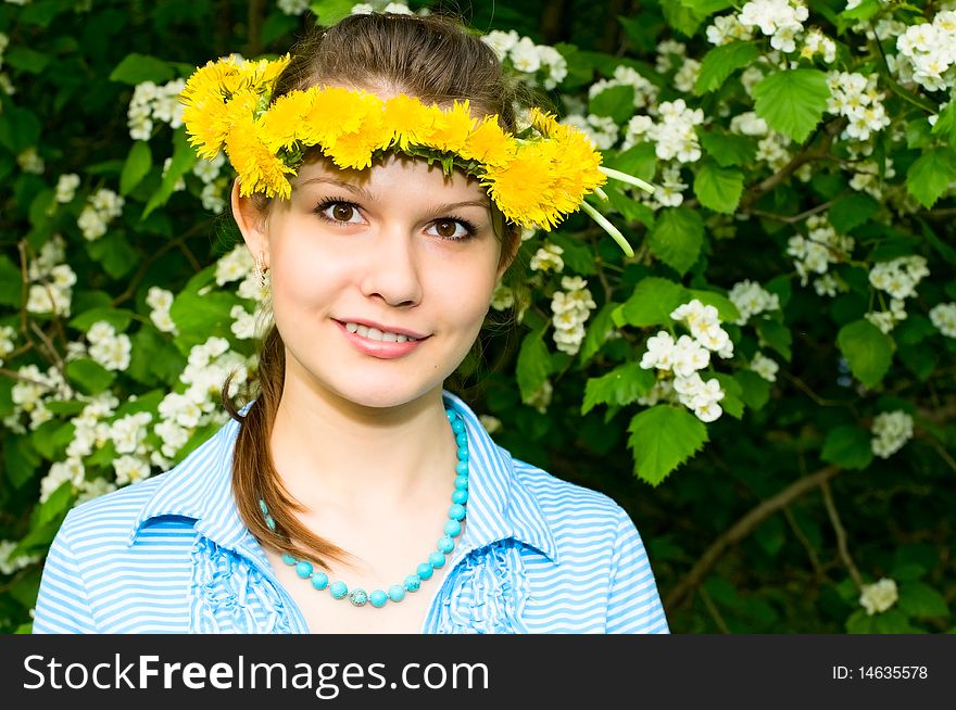 Portrait of young smiling woman in dandelion garland. Portrait of young smiling woman in dandelion garland