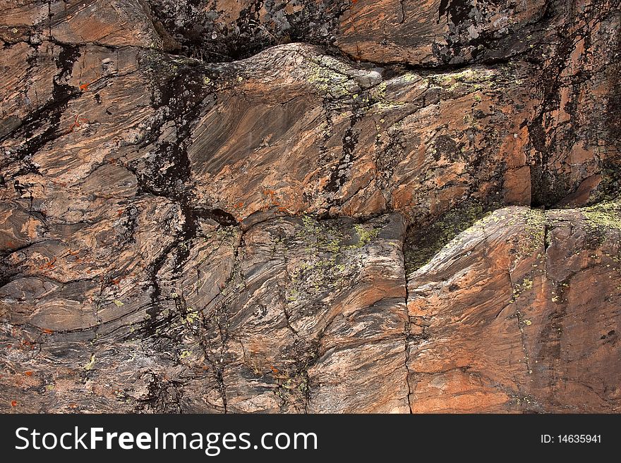 Texture of stone wall in mountains showing variation of color. Texture of stone wall in mountains showing variation of color