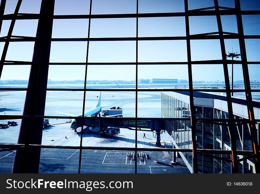 Parked aircraft on an airport through the gate window