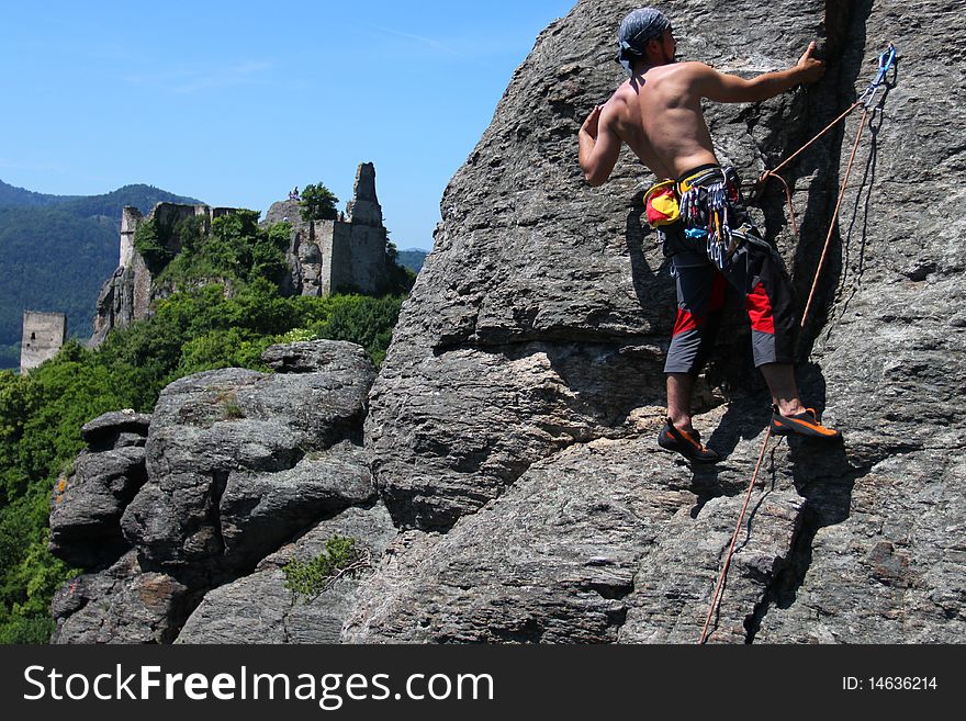 Climber  on a granite wall with landscape view