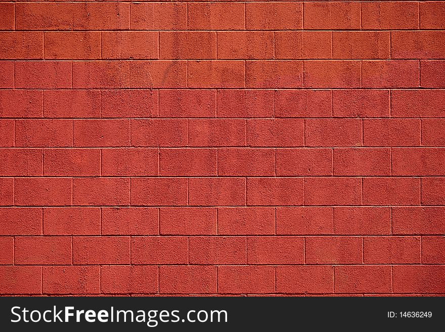 A view of a painted wall of cememt blocks in the deep color of red. A view of a painted wall of cememt blocks in the deep color of red.