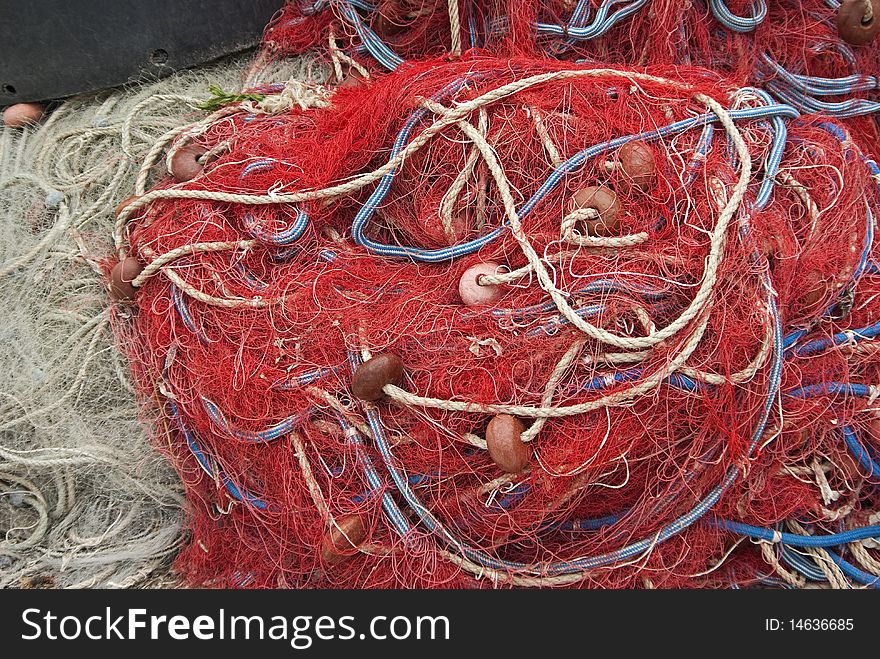 Heap of fishing nets with ropes and floats.