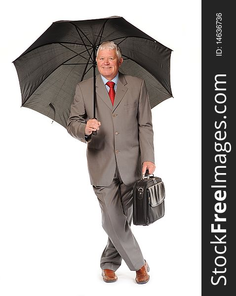 Successful mature business man on white background, with umbrella and briefcase. Successful mature business man on white background, with umbrella and briefcase