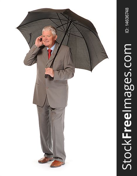 Successful mature business man on white background, with umbrella and phone. Successful mature business man on white background, with umbrella and phone