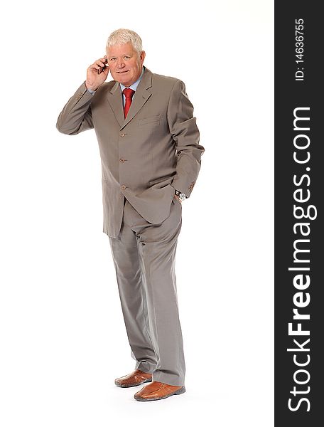 Successful mature business man on white background, using a cellphone or mobile. Successful mature business man on white background, using a cellphone or mobile