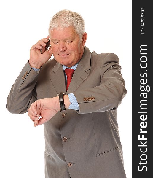 Successful mature businessman using phone