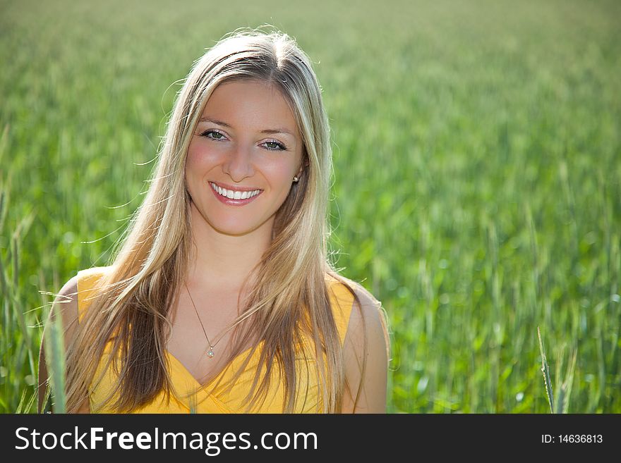 Smiling girl on field portrait in full sun. Smiling girl on field portrait in full sun