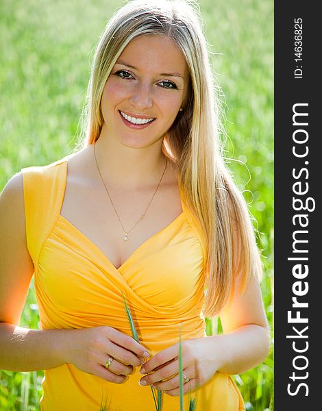 Smiling girl on field portrait in full sun. Smiling girl on field portrait in full sun