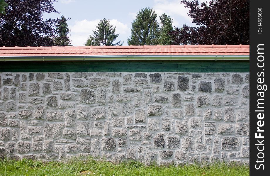 Stone wall with red roof
