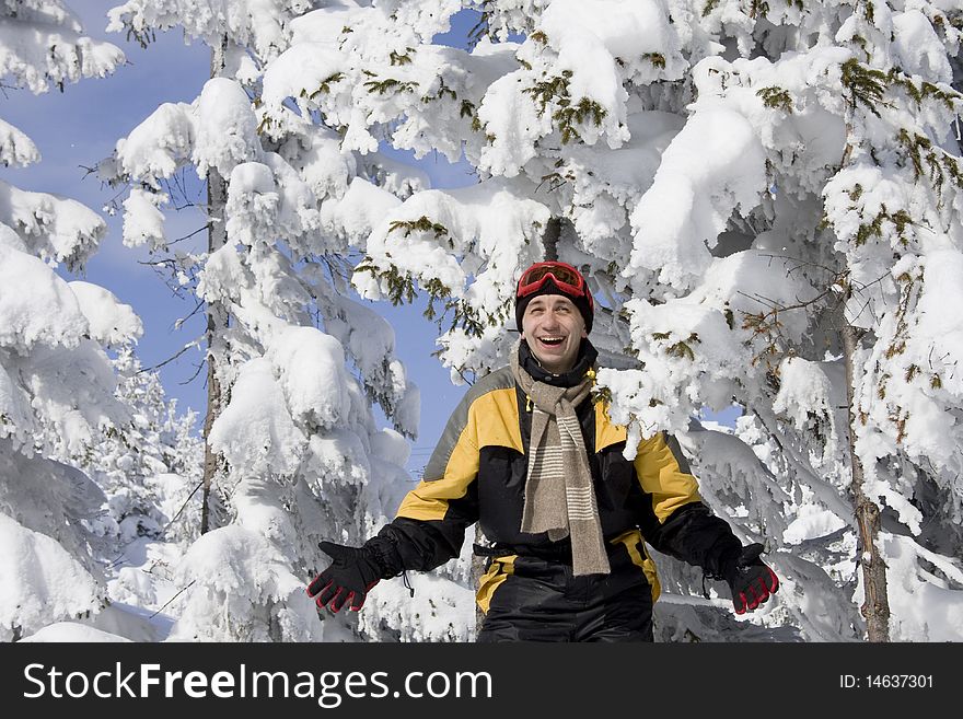 Young Man On A Background Snow-bound Fir-trees