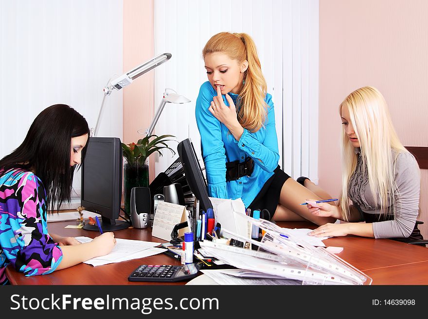 Three girls working in the office. Three girls working in the office