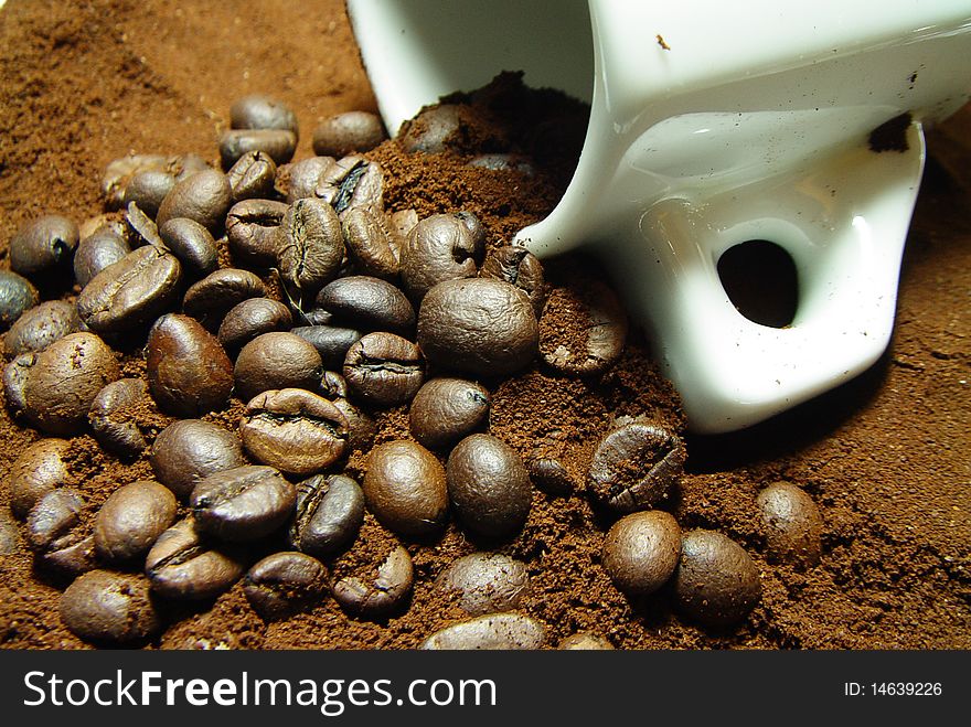 Roasted coffee beans with coffee and espresso cup