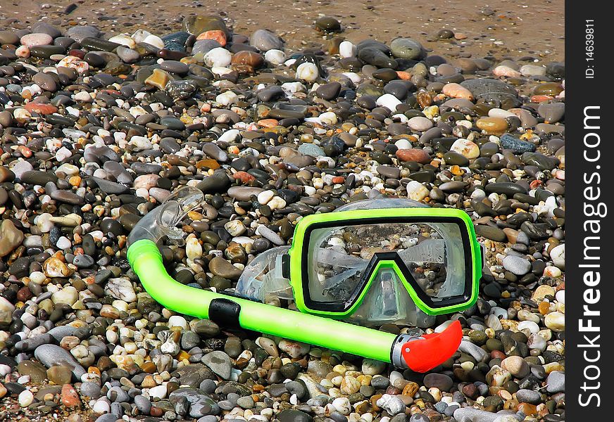 Mask and tube for a scuba diving lying on the bank of Black sea in Crimea