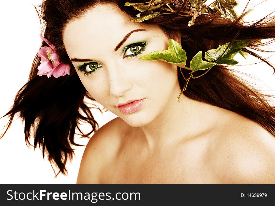 A beautiful young woman with flowers in her hair. A beautiful young woman with flowers in her hair.