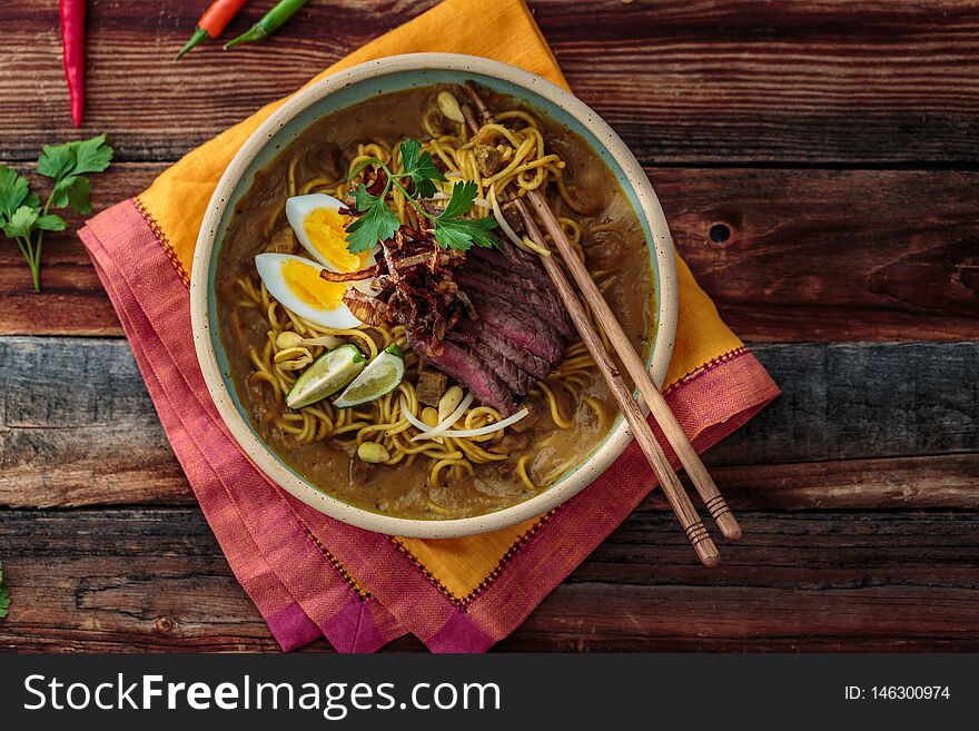 Malaysia Spicy Noodle Mee Rebus With Beef Egg and fried onion, copy space