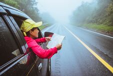 Asian Women Travel Relax In The Holiday. Traveling By Car Park. View Map For Nature Tours During The Rainy Season Royalty Free Stock Photography Asian Women Travel Relax In The Holiday. Traveling By Car Park. View Map For Nature Tours During The Rainy Season Royalty Free Stock Photography