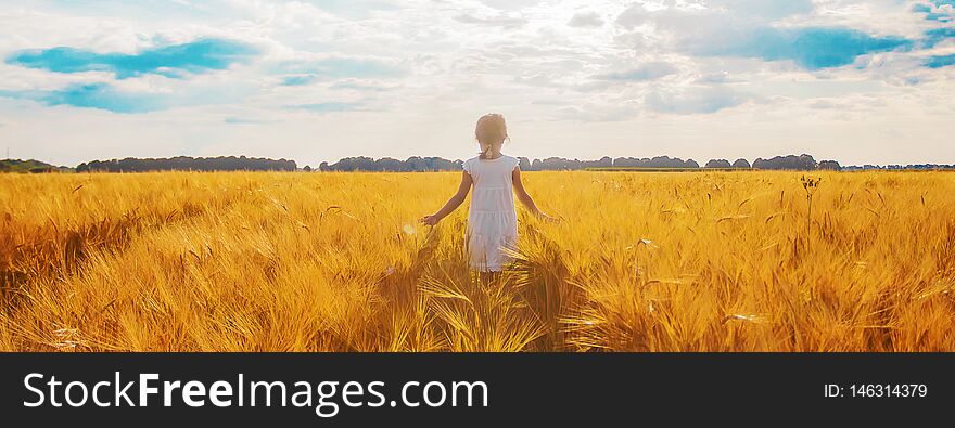 Child In A Wheat Field. Selective Focus