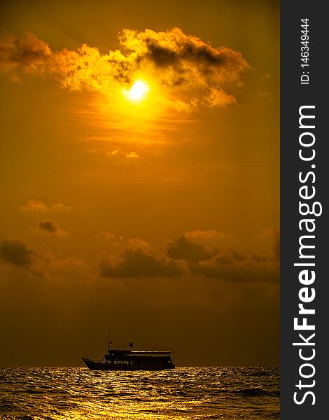 Boat on texture of tropical sea water and wave in golden light of sunset. Boat on texture of tropical sea water and wave in golden light of sunset