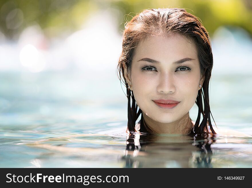 Face of  middle aged woman in clear water and looking to camera with copyspace on left. Face of  middle aged woman in clear water and looking to camera with copyspace on left