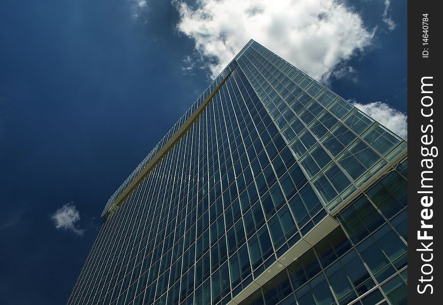 Down view on modern building with blue sky and clouds. Down view on modern building with blue sky and clouds
