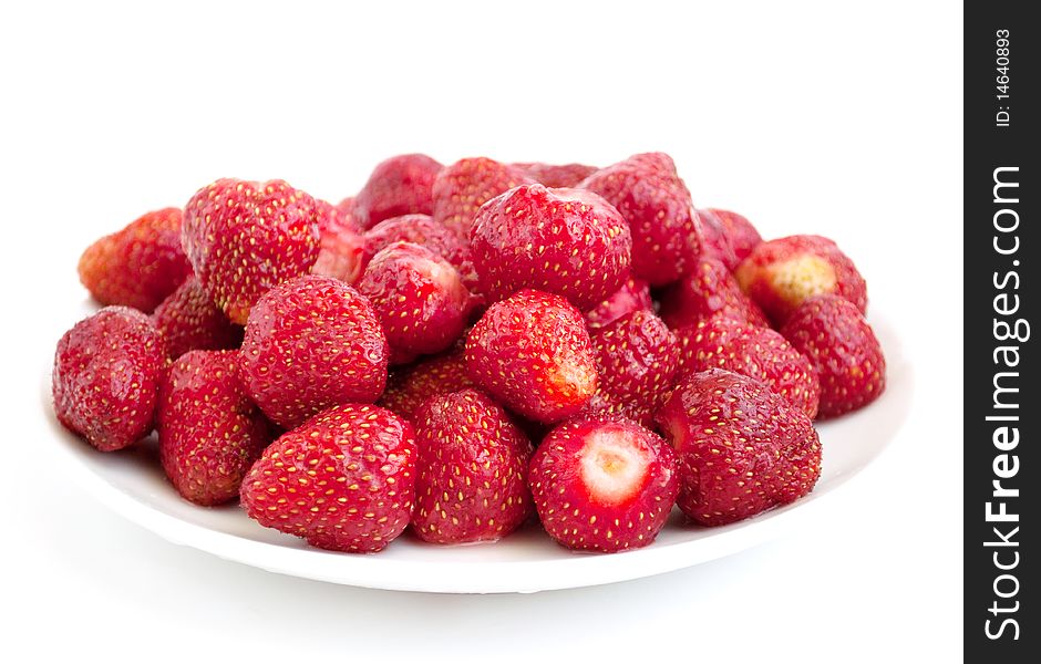 Ripe strawberry in a plate on a white background