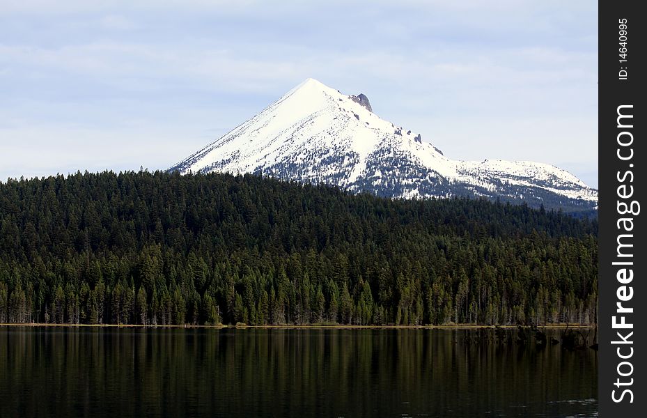 The snow-capped peak of Mount McLoughlin rises above the pine forest that surrounds the popular Lake of the Woods in southern Oregon. The snow-capped peak of Mount McLoughlin rises above the pine forest that surrounds the popular Lake of the Woods in southern Oregon.