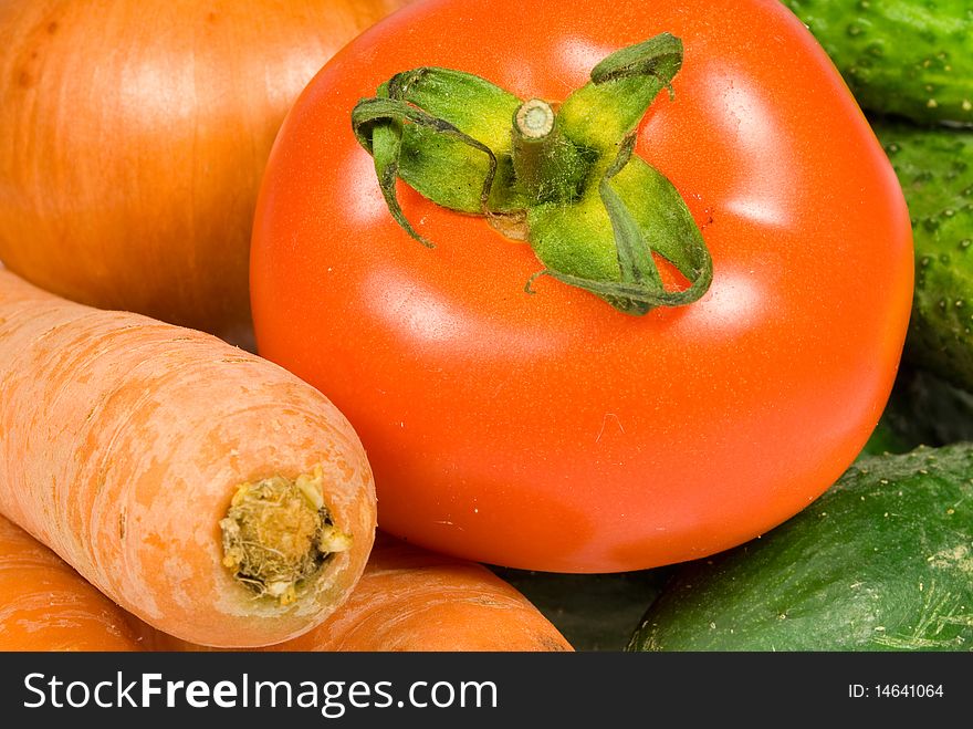 Carrot, onion, cucumber and tomato. background