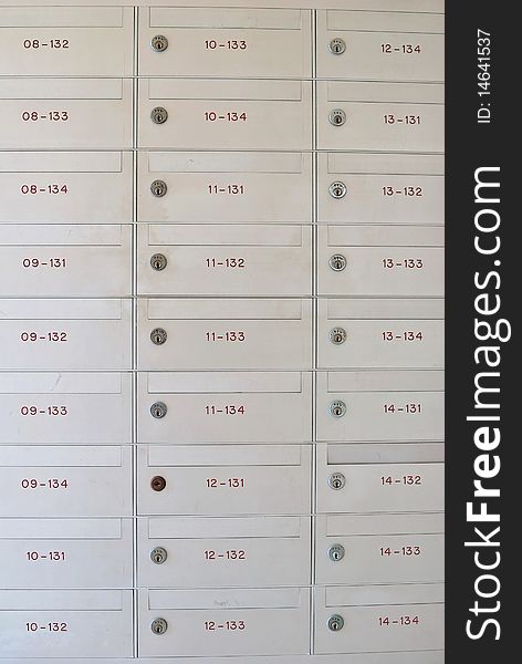 Row of metallic letter boxes with numbers and locks. For concepts such as safety and security, business communication and concepts. Row of metallic letter boxes with numbers and locks. For concepts such as safety and security, business communication and concepts.