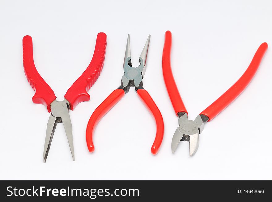 3 red handle of pliers on a white background.