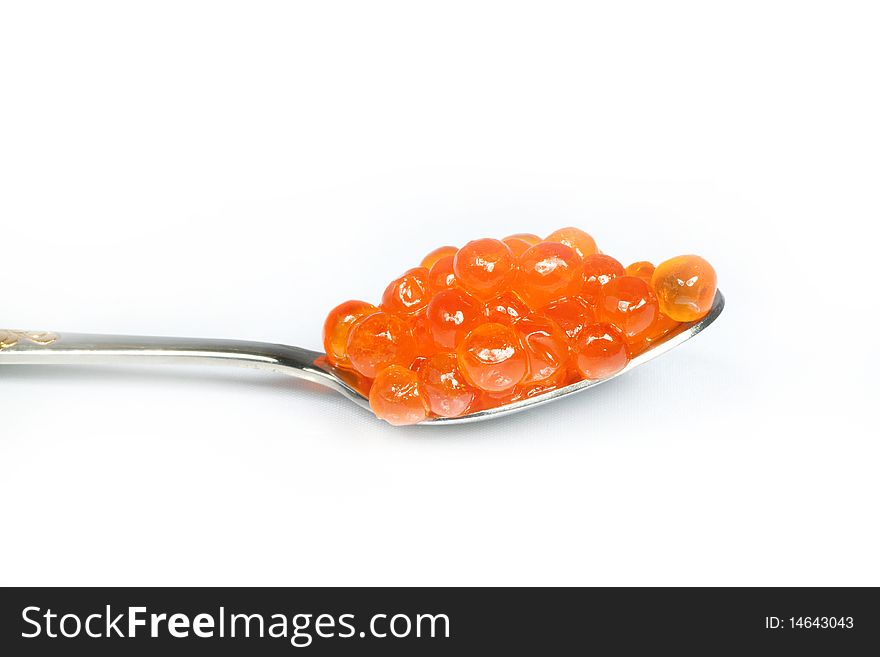 Teaspoon red caviar over white background