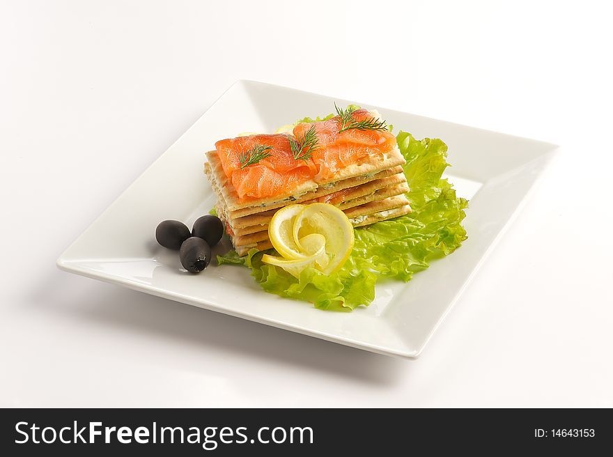 Fish appetizer with salmon from the toast with lemon and olives