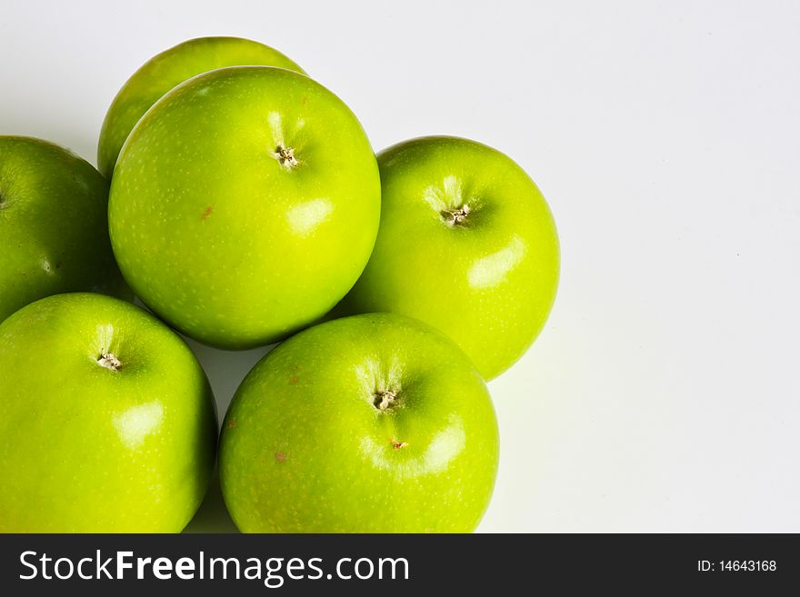 One green apple is stacking on 5-piece base. One green apple is stacking on 5-piece base